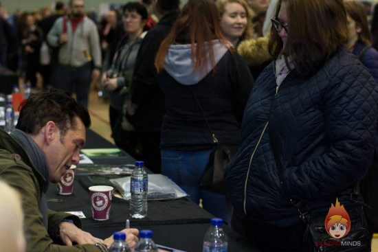 Royd Tolkien signs his photograph for Chrissie Wood at Wales Comic Con 2017 (Photo Karen Woodham/BlazingMinds)