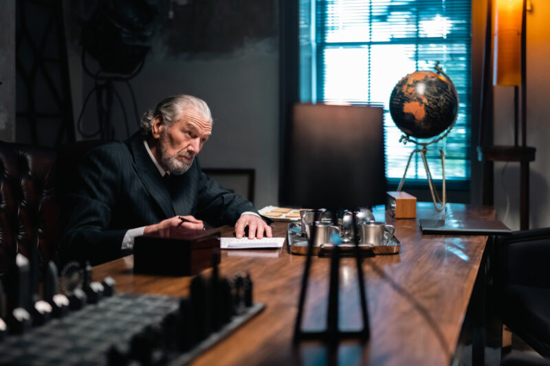 Clive Russel at his desk in Tales of Babylon