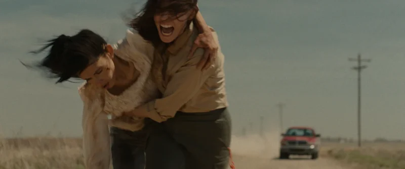 Ellen Adair as Jamie Miller carries Mitzi Akaha as Alex Kanai