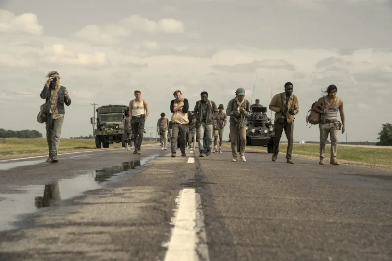 Movie still from The Long Walk showing characters pushing through exhaustion and rivalry.